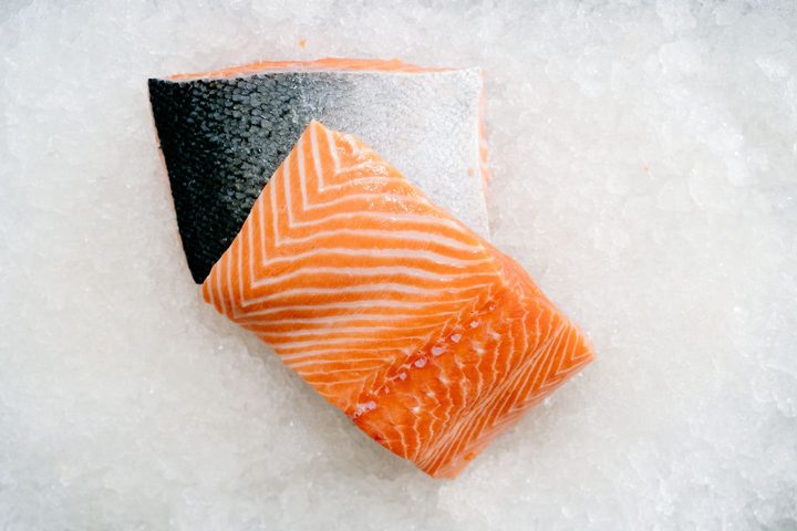 Salmon portion resting on ice